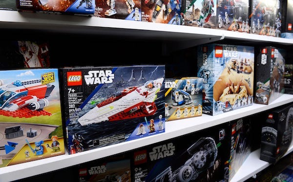 Boxes of Lego figures on a store shelf