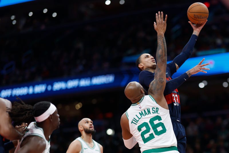 Washington Wizards forward Kyle Kuzma (33) shoots the ball as Boston Celtics forward Xavier Tillman (26) defends in the second half at Capital One Arena.