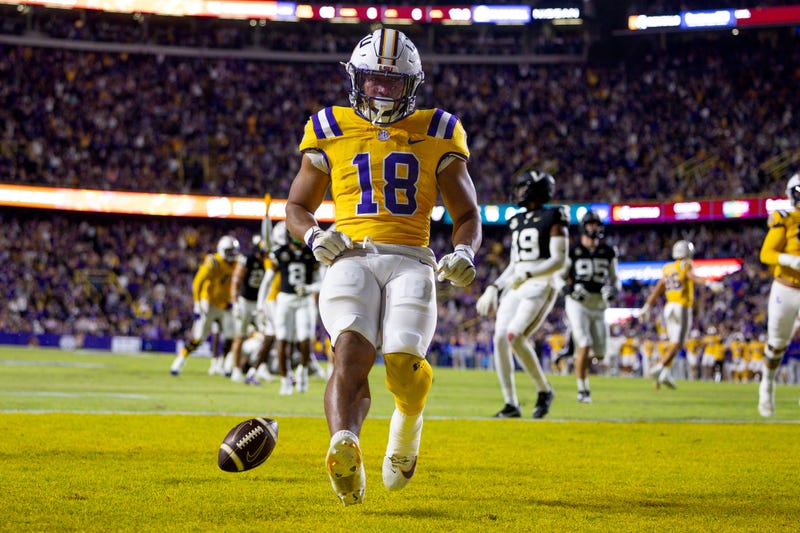 Nov 23, 2024; Baton Rouge, Louisiana, USA; LSU Tigers running back Josh Williams (18) scores a touchdown against Vanderbilt Commodores linebacker Bryan Longwell (4) during the first half at Tiger Stadium.