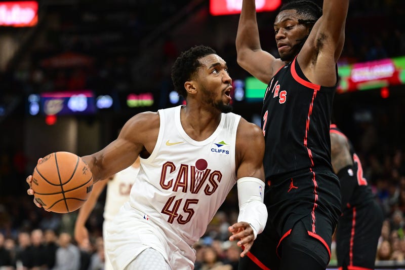 Cavaliers guard Donovan Mitchell (45) drives to the basket against Toronto Raptors forward Jonathan Mogbo (2) during the first half at Rocket Mortgage FieldHouse