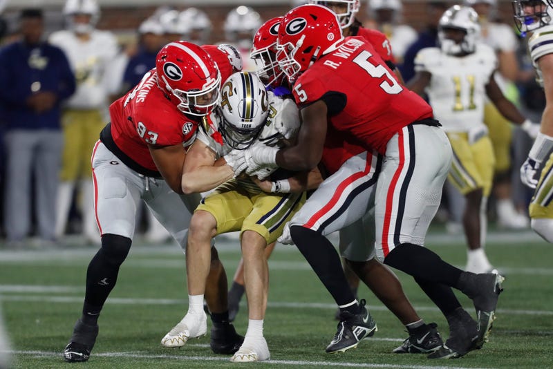The Georgia defense stops Georgia Tech quarterback Haynes King (10) during the second half of a NCAA college football game against Georgia Tech in Atlanta, on Saturday, Nov. 25, 2023.Georgia won 31-23.