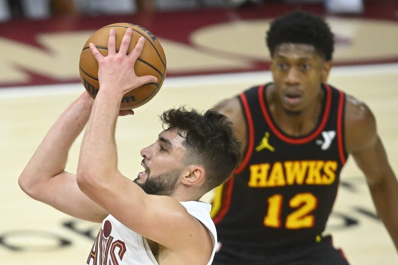 Nov 27, 2024; Cleveland, Ohio, USA; Cleveland Cavaliers guard Ty Jerome (2) shoots beside Atlanta Hawks forward De'Andre Hunter (12) in the third quarter at Rocket Mortgage FieldHouse.