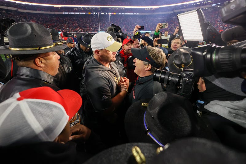 Nov 29, 2024; Athens, Georgia, USA; Georgia Tech Yellow Jackets head coach Brent Key talks to Georgia Bulldogs head coach Kirby Smart after an eight overtime game at Sanford Stadium. Mandatory Credit: Brett Davis-Imagn Images