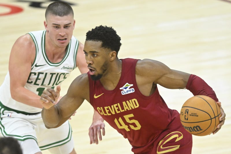 Dec 1, 2024; Cleveland, Ohio, USA; Cleveland Cavaliers guard Donovan Mitchell (45) dribbles beside Boston Celtics guard Payton Pritchard (11) in the third quarter at Rocket Mortgage FieldHouse.
