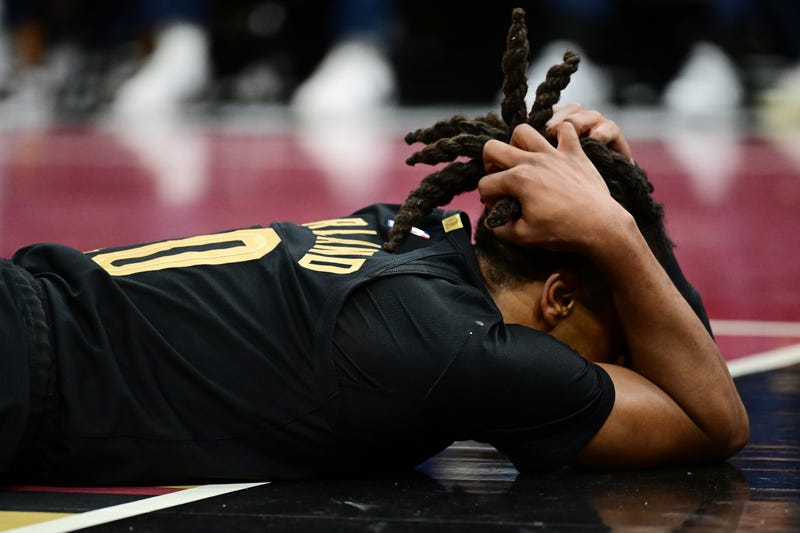 Dec 3, 2024; Cleveland, Ohio, USA; Cleveland Cavaliers guard Darius Garland (10) lies on the court after colliding with Washington Wizards center Jonas Valanciunas (not pictured) during the second half at Rocket Mortgage FieldHouse.