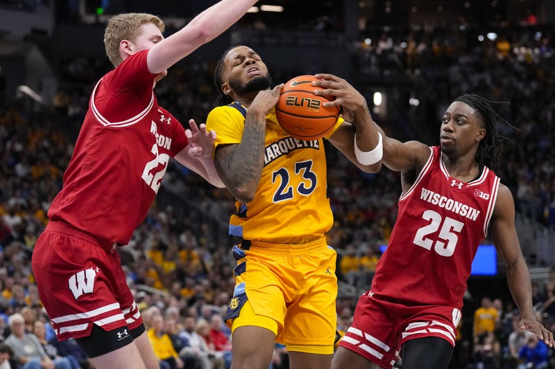 Dec 7, 2024; Milwaukee, Wisconsin, USA; Marquette Golden Eagles forward David Joplin (23) drives for the basket between Wisconsin Badgers forward Steven Crowl (22) and guard John Blackwell (25) during the second half at Fiserv Forum. Mandatory Credit: Jeff Hanisch-Imagn Images
