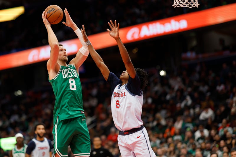 Boston Celtics center Kristaps Porzingis (8) shoots the ball as Washington Wizards guard Bub Carrington (8) defends in the second quarter at Capital One Arena.