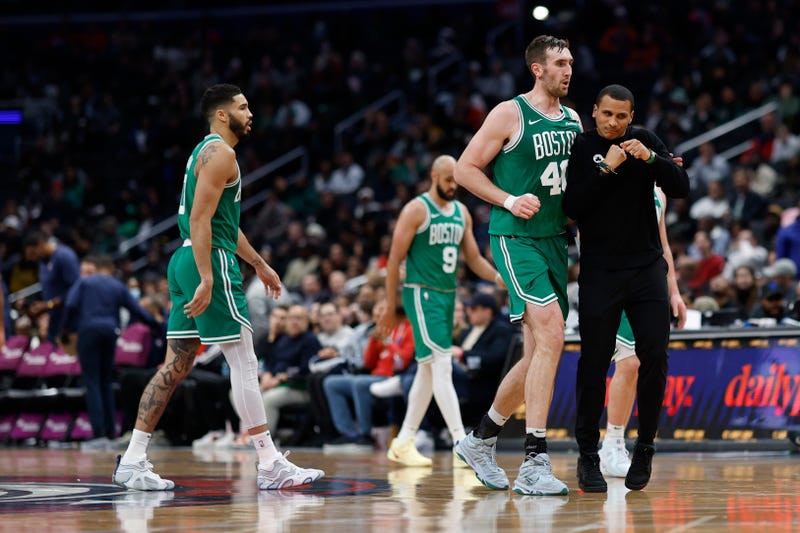 Boston Celtics head coach Joe Mazzulla (R) celebrates with Celtics center Luke Kornet (40) after a called timeout against the Washington Wizards in the third quarter at Capital One Arena.