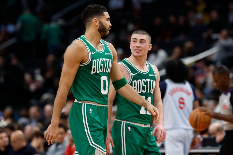 Boston Celtics forward Jayson Tatum (0) talks with Celtics guard Payton Pritchard (11) during a timeout against the Washington Wizards in the third quarter at Capital One Arena. 