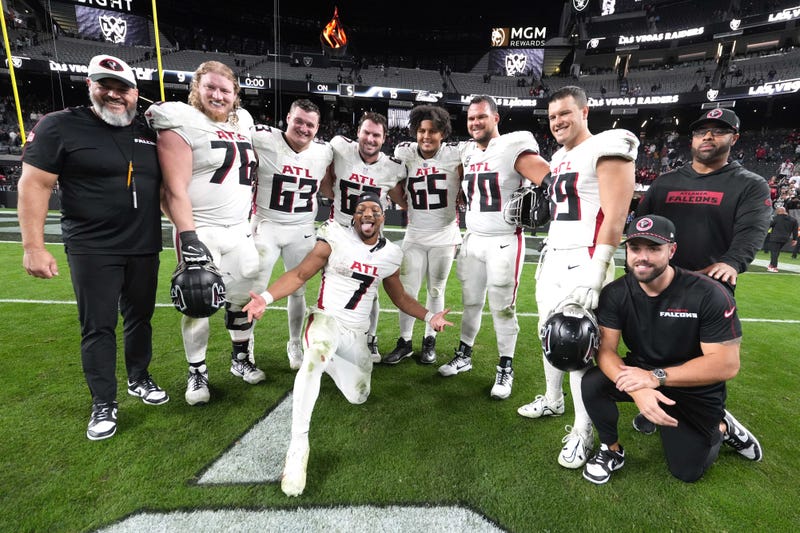 Atlanta Falcons running back Bijan Robinson (7) poses with offensive tackle Kaleb McGary (76), guard Chris Lindstrom (63), center Drew Dalman (67), guard Matthew Bergeron (65), offensive tackle Jake Matthews (70) and tight end Charlie Woerner (89) after the game against the Las Vegas Raiders at Allegiant Stadium.