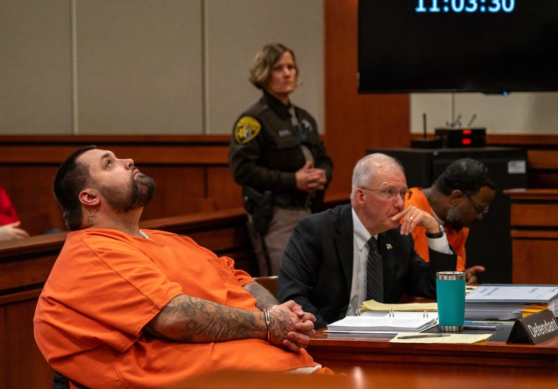 Carlos Hernandez, left, attorney Michael McCarthy, center, and Joshua Zuazo, right