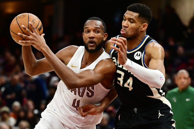 Dec 20, 2024; Cleveland, Ohio, USA; Cleveland Cavaliers forward Evan Mobley (4) drives to the basket against Milwaukee Bucks forward Giannis Antetokounmpo (34) during the second half at Rocket Mortgage FieldHouse
