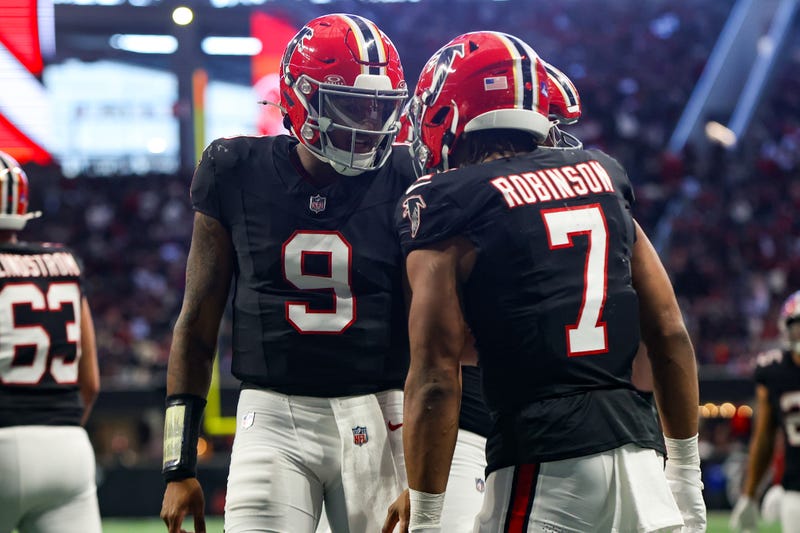 Atlanta Falcons running back Bijan Robinson (7) celebrates after a touchdown with quarterback Michael Penix Jr. (9) against the New York Giants in the second quarter at Mercedes-Benz Stadium.
