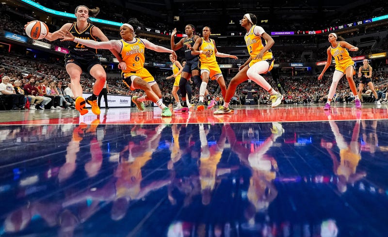 Indiana Fever guard Caitlin Clark (22) rushes up the court against Los Angeles Sparks Odyssey Sims (6) on Wednesday, Sept. 4, 2024, during the game at Gainbridge Fieldhouse in Indianapolis. The Indiana Fever defeated the Los Angeles Sparks, 93-86.