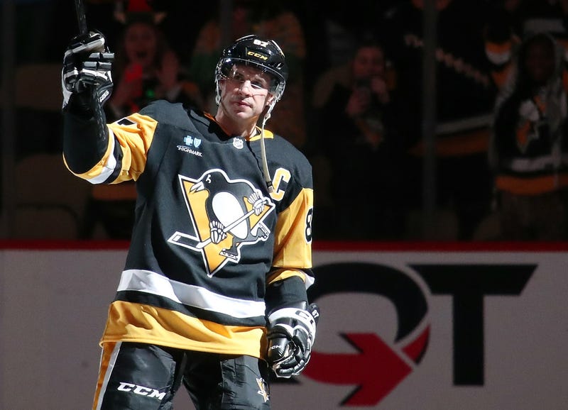 Sidney Crosby with stick in the air