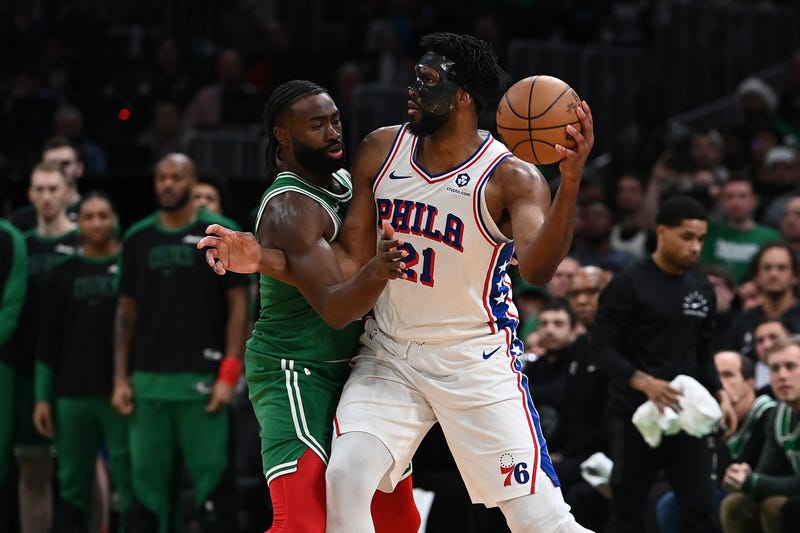 Philadelphia 76ers center Joel Embiid (21) passes the ball against Boston Celtics guard Jaylen Brown (7) during the second half at TD Garden.