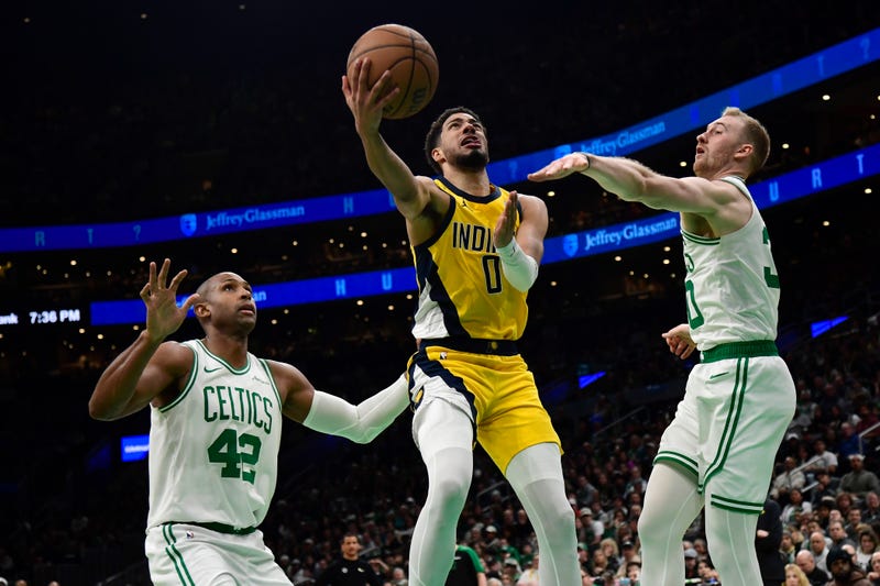 Indiana Pacers guard Tyrese Haliburton (0) drives to the basket between Boston Celtics center Al Horford (42) and forward Sam Hauser (30) during the second half at TD Garden.