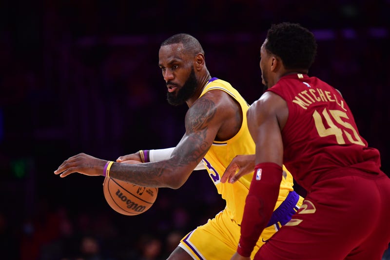Los Angeles Lakers forward LeBron James (23) moves the ball against Cleveland Cavaliers guard Donovan Mitchell (45) during a game this past season.