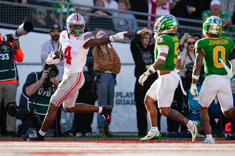 Ohio State Buckeyes wide receiver Jeremiah Smith (4) scores a touchdown in front of Oregon Ducks defensive back Kobe Savage (5) and defensive back Tysheem Johnson (0) during the first half of the College Football Playoff quarterfinal at the Rose Bowl in Pasadena, Calif. on Jan. 1, 2025.