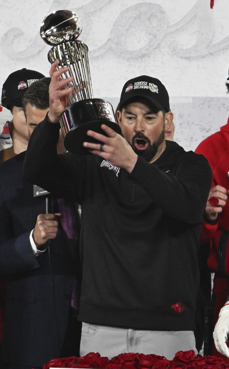 Jan 1, 2025; Pasadena, CA, USA; Ohio State Buckeyes head coach Ryan Day holds up the Roae Bowl game championship trophy after defeating the Oregon Ducks at Rose Bowl Stadium. 