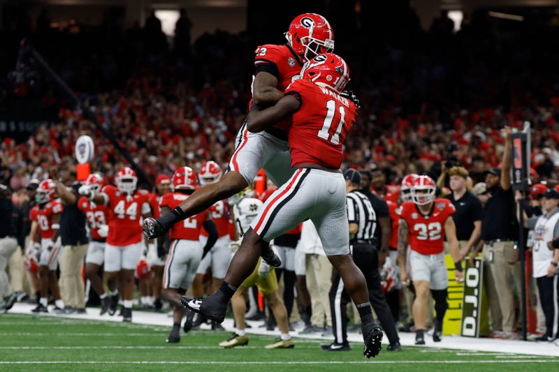 Georgia Bulldogs linebacker Jalon Walker (11) celebrates with Bulldogs defensive lineman Mykel Williams (13) after making a defensive stop