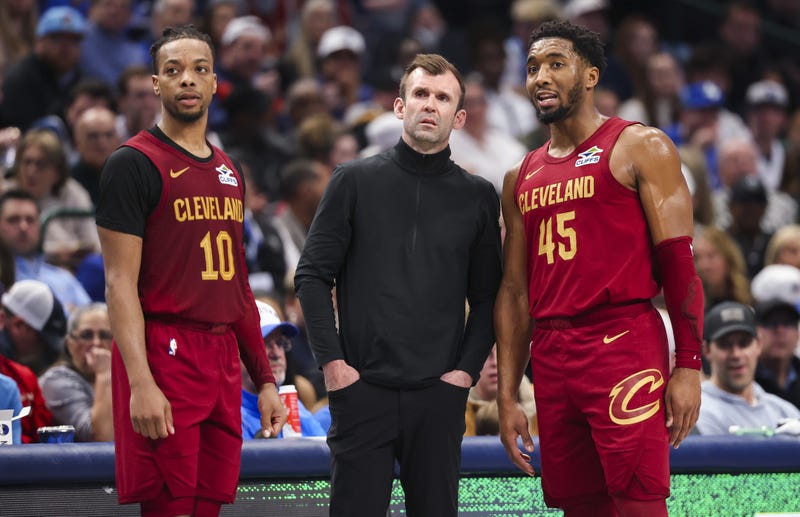 Jan 3, 2025; Dallas, Texas, USA; Cleveland Cavaliers head coach Kenny Atkinson speaks with Cleveland Cavaliers guard Darius Garland (10) and Cleveland Cavaliers guard Donovan Mitchell (45) during the first half against the Dallas Mavericks at American Airlines Center.