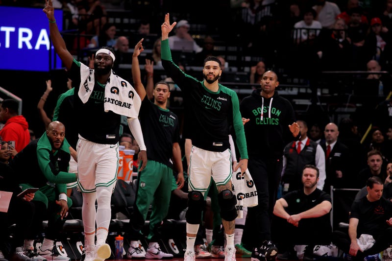 Boston Celtics players on the bench react after a made basket by Boston Celtics guard Payton Pritchard (11, not shown) during the fourth quarter at Toyota Center.