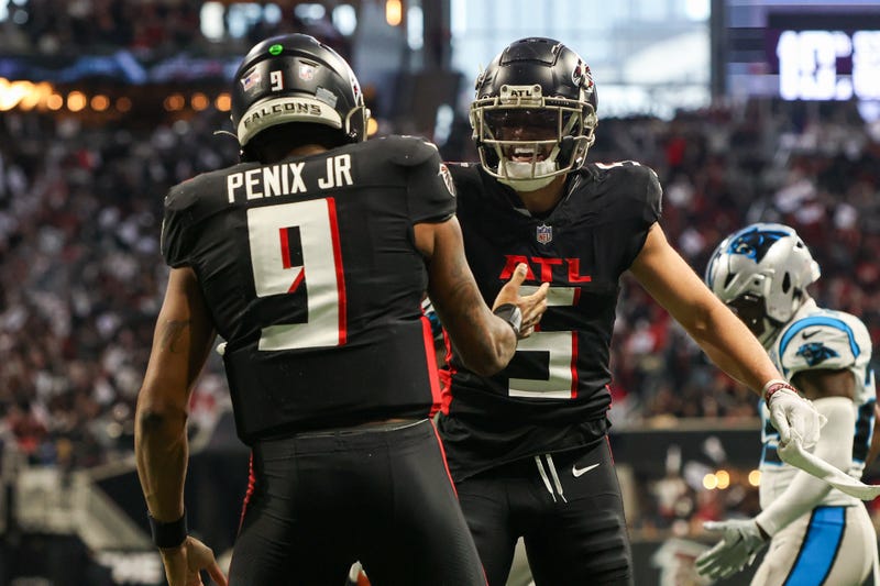 Atlanta Falcons quarterback Michael Penix Jr. (9) celebrates with wide receiver Drake London (5) after a touchdown run against the Carolina Panthers in the second quarter at Mercedes-Benz Stadium