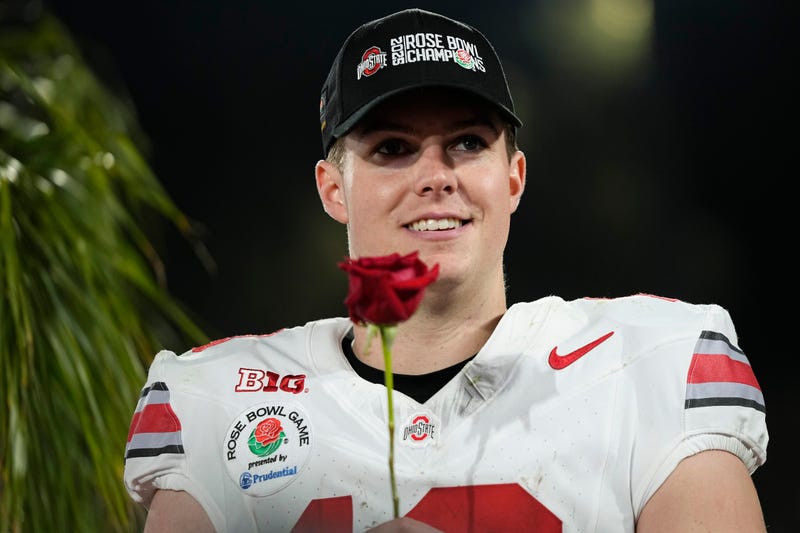 Ohio State Buckeyes quarterback Will Howard (18) holds a rose following the College Football Playoff quarterfinal against the Oregon Ducks at the Rose Bowl in Pasadena, Calif. on Jan. 1, 2025. Ohio State won 41-21.