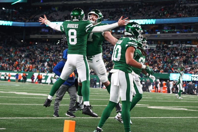 Aaron Rodgers jumping into air with teammate