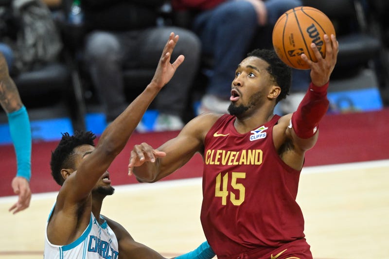 Jan 5, 2025; Cleveland, Ohio, USA; Cleveland Cavaliers guard Donovan Mitchell (45) shoots beside Charlotte Hornets forward Brandon Miller (24) in the fourth quarter at Rocket Mortgage FieldHouse.