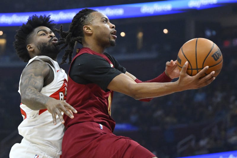 Jan 9, 2025; Cleveland, Ohio, USA; Cleveland Cavaliers guard Darius Garland (10) drives to the basket beside Toronto Raptors guard Jamal Shead (23) in the first quarter at Rocket Mortgage FieldHouse. 