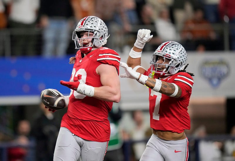 Ohio State Buckeyes defensive end Jack Sawyer (33) celebrates his touchdown return with Ohio State Buckeyes cornerback Jordan Hancock (7) against Texas Longhorns in the fourth quarter of the Cotton Bowl Classic during the College Football Playoff semifinal game at AT&T Stadium in Arlington, Texas on January, 10, 2025.