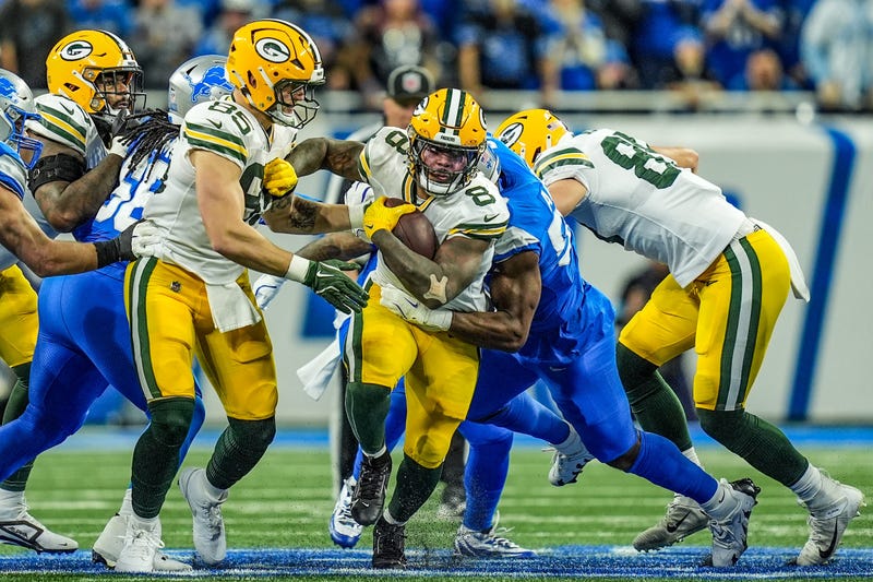 Green Bay Packers running back Josh Jacobs breaks through the Detroit Lions defensive line before being tackled during the Thursday Night Football game at Ford Field in Detroit on Thursday, Dec. 5, 2024. Jacobs scored three rushing touchdowns in the Lions' 34-31 win.