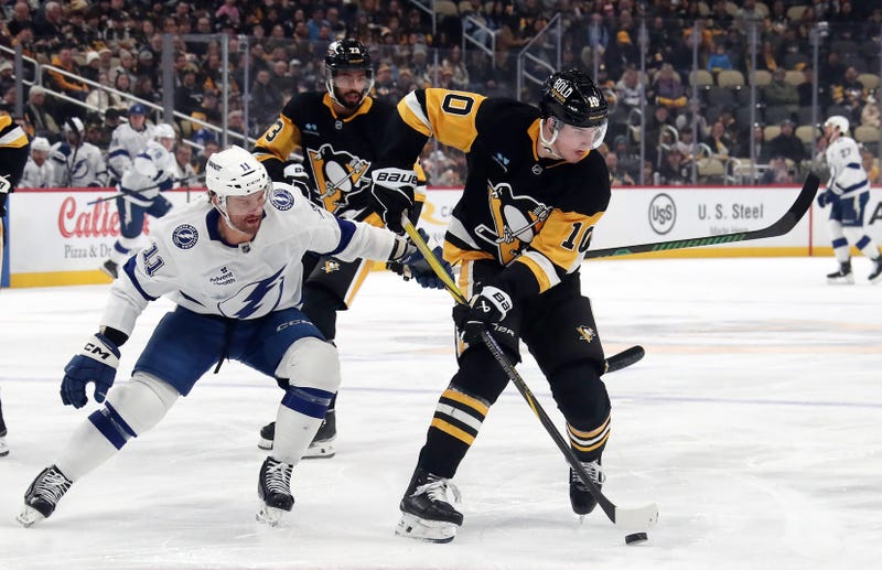 Pittsburgh Penguins left wing Drew O'Connor (10) moves the puck against Tampa Bay Lightning center Luke Glendening (11) during the first period