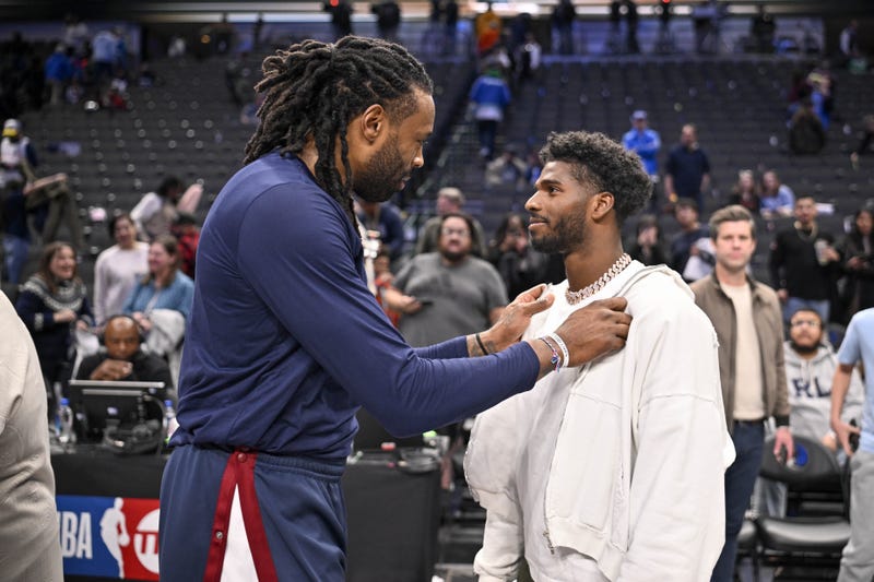 Jan 14, 2025; Dallas, Texas, USA; Denver Nuggets center DeAndre Jordan (left) talks with Colorado Buffaloes quarterback Shedeur Sanders after the game between the Dallas Mavericks and the Nuggets at the American Airlines Center.