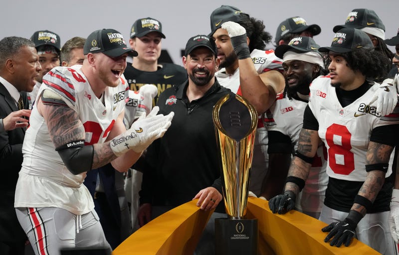 Jan 20, 2025; Atlanta, GA, USA; Ohio State Buckeyes defensive end Jack Sawyer (33) and Ohio State Buckeyes head coach Ryan Day celebrate on the podium after defeating the Notre Dame Fighting Irish in the CFP National Championship college football game at Mercedes-Benz Stadium. Mandatory Credit: Kirby Lee-Imagn Images