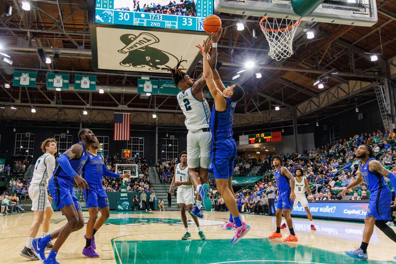 Jan 30, 2025; New Orleans, Louisiana, USA; Tulane Green Wave forward Greg Glenn III (2) drives to the basket against Memphis Tigers forward Nicholas Jourdain (2) during the second half at Avron B. Fogelman Arena in Devlin Fieldhouse. The university announced July 28 that Glenn had been killed in an accident.