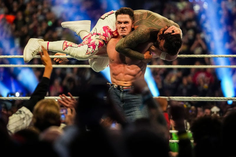 John Cena holds Jey Uso on his shoulders Saturday, Feb. 1, 2025, during the WWE Royal Rumble at Lucas Oil Stadium in Indianapolis.