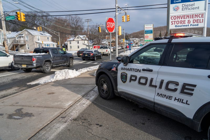 A Wharton Police officer helps direct traffic on local roads as a sinkhole closes Interstate 80 eastbound near Exit 34 in Wharton on Monday, Feb. 10, 2025