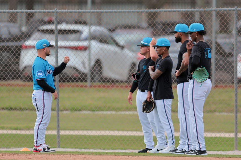 Feb 13, 2025; Jupiter, FL, USA; Miami Marlins first base coach Tyler Smarslok (31) talks to Miami Marlins starting pitcher Sandy Alcantara (22) and starting pitcher Edward Cabrera (27) during a spring training workout at the Miami Marlins player development & scouting complex. Mandatory Credit: Sam Navarro-Imagn Images