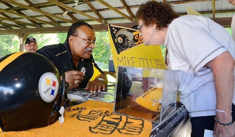 Former Pittsburgh Steeler Mike Collier signs autographs during a fundraiser at Funkstown American Legion on June 28, 2013.