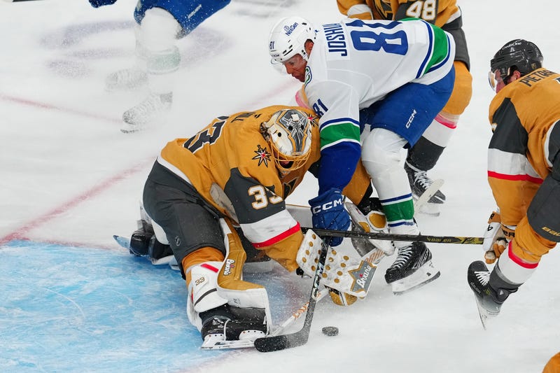 Vegas Golden Knights goaltender Adin Hill (33) makes a save against Vancouver Canucks center Dakota Joshua (81) during the third period at T-Mobile Arena.