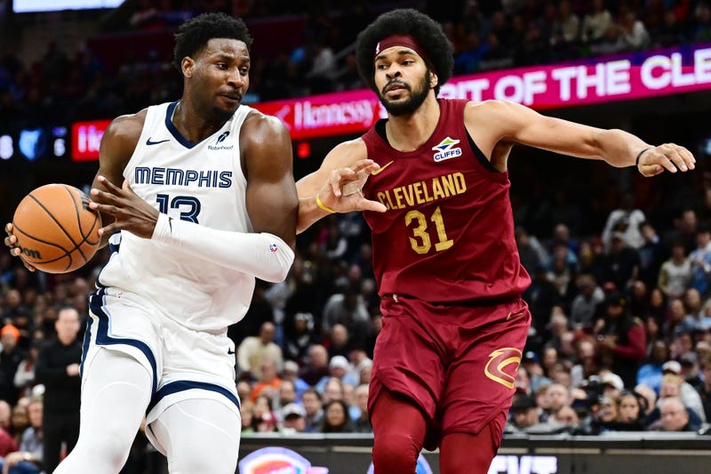 Feb 23, 2025; Cleveland, Ohio, USA; Memphis Grizzlies forward Jaren Jackson Jr. (13) drives to the basket against Cleveland Cavaliers center Jarrett Allen (31) during the second half at Rocket Arena