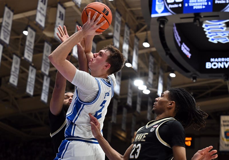 Mar 3, 2025; Durham, North Carolina, USA; Duke Blue Devils forward Cooper Flagg (2) lays the ball up over Wake Forest Demon Deacons center Efton Reid III (4) during the second half at Cameron Indoor Stadium. 