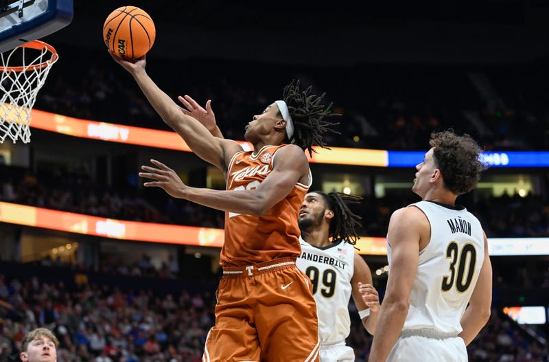 Texas guard Tre Johnson (20) drives past Vanderbilt guard Chris Manon (30) and forward Devin McGlockton (99) during the first half at Bridgestone Arena in Nashville, Tenn., Wednesday, March 12, 2025.