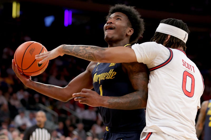 Mar 14, 2025; New York, NY, USA; Marquette Golden Eagles guard Kam Jones (1) drives to the basket against St. John's Red Storm guard Aaron Scott (0) during the first half at Madison Square Garden. Mandatory Credit: Brad Penner-Imagn Images