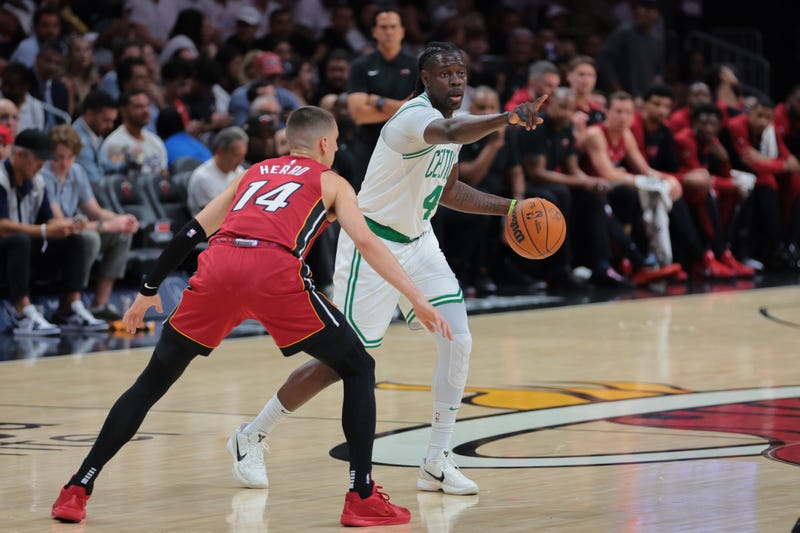 Boston Celtics guard Jrue Holiday (4) signals as Miami Heat guard Tyler Herro (14) defends during the first quarter at Kaseya Center.