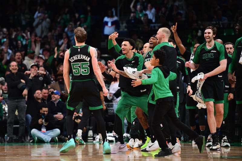 Boston Celtics forward Baylor Scheierman (55) reacts with the bench after hitting a three point shot during the second half at TD Garden.