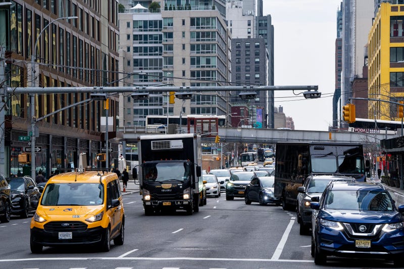 Traffic pass under congestion pricing toll readers at West 41st Street and 10th Avenue in March